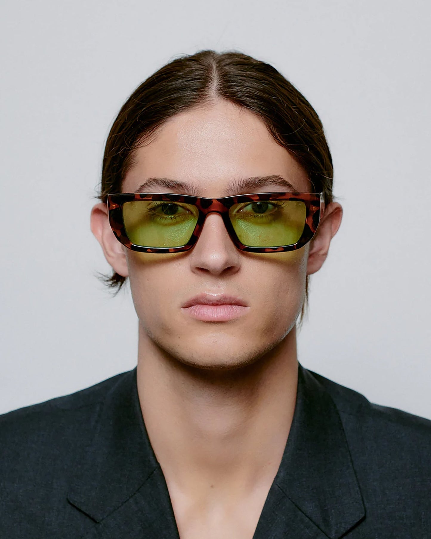Person wearing sunglasses with a neutral background