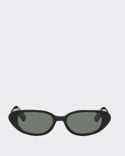 Black cat-eye sunglasses with dark lenses on a light gray background