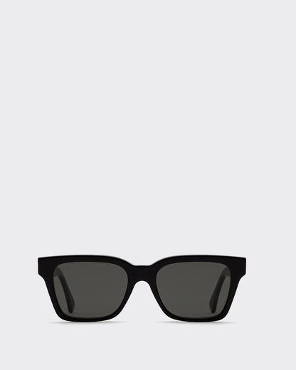 Black sunglasses with dark lenses on a light gray background gold accent