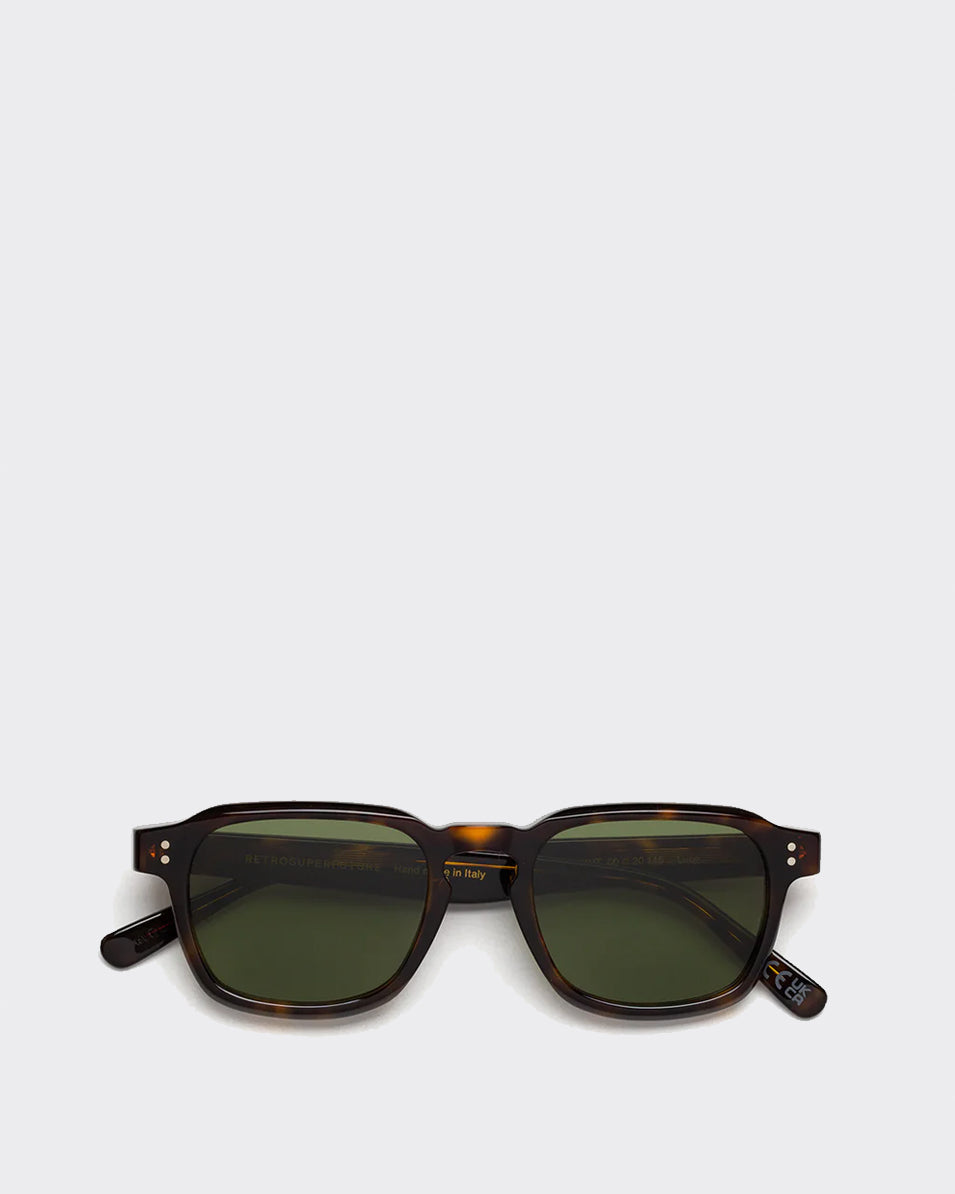 Sunglasses with tortoiseshell frame and green lenses on a light gray background